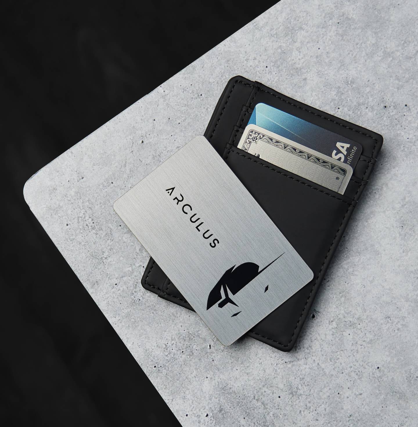 An Arculus card and leather wallet resting on a desk