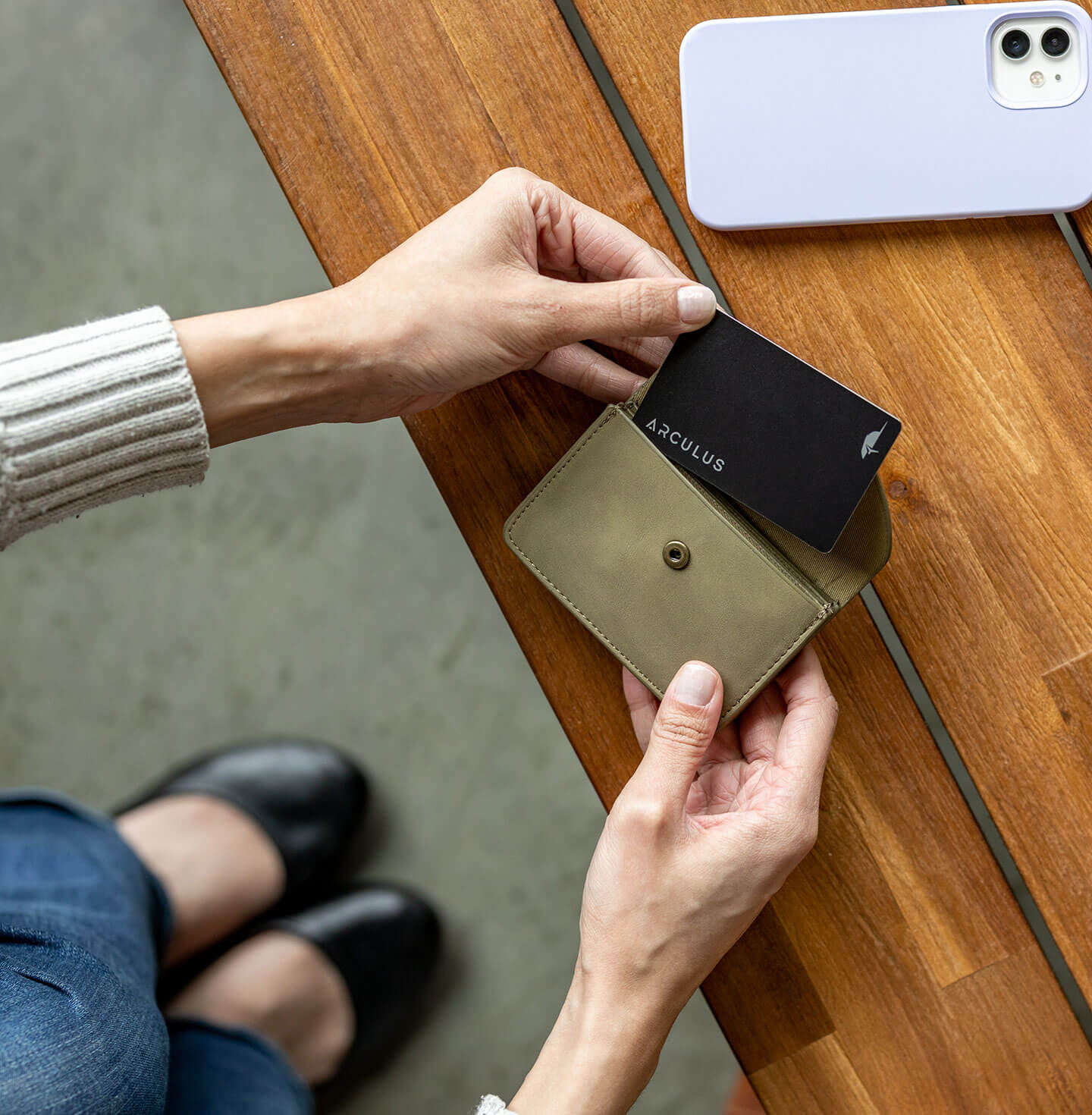 An Arculus card and leather wallet resting on a desk